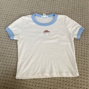 Cute tee shirt with small mushroom.